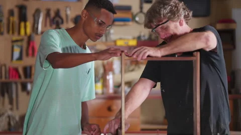Master Carpenter Working with Apprentice at Carpentry Workshop, Senior Boss.. Stock Footage 247306353