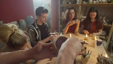 A master ceramist conducts a group class on ceramics for adults. Stock Footage 245749532