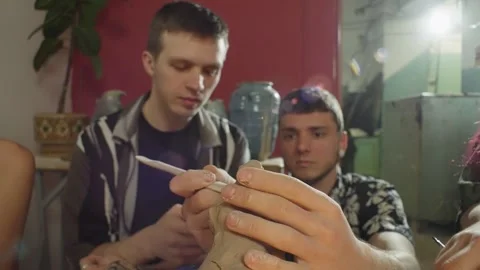 The master ceramist makes small adjustments to the student's sculpture. Stock-Footage 244651050