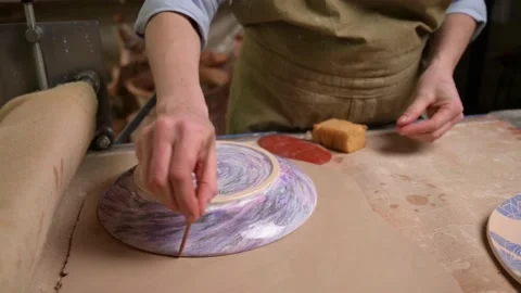 Master ceramist works in pottery studio. Process of creating plate Stock Footage 170603717