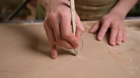 Master ceramist works in pottery studio. Process of creating plate Stock Footage 170604068