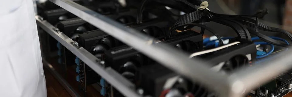 Master checking cryptocurrency mining rig using graphic cards closeup Stock Photos