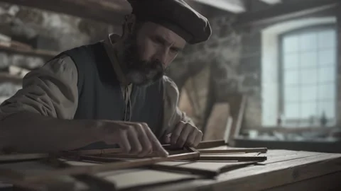 Master checking smoothness of a wooden wing component with a finger, workshop Stock Footage 337649745