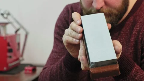 The master checks the evenness of the grindstone before sharpening Video stock 173234848