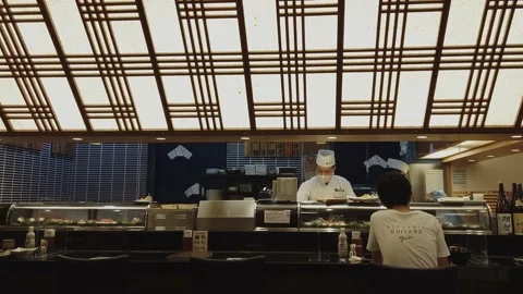 The master chef prepares sushi for his customers in his shop Stock Footage 139032259
