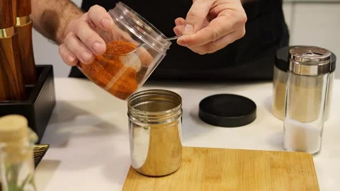 Master chef skillfully blends spices in containers, creating flavorful cuisine Stock Footage 274542149