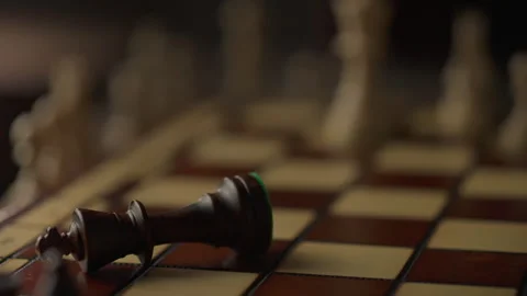 A master chess player demonstrates his superiority by knocking over the king Stock Footage 275088453
