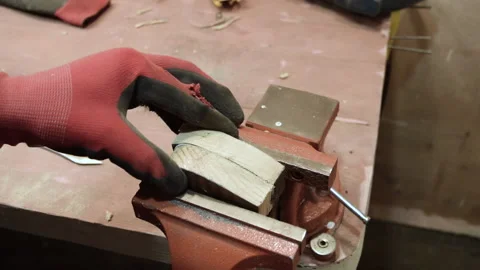 The master clamps two bars of wood in a vice. Stock Footage 156178604