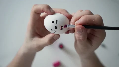 A master class on coloring eggs. Close up view painting Easter eggs with special Video stock 181569996