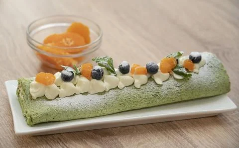 Master class on cooking desserts. Ready pistachio roll close-up. Stock Photos