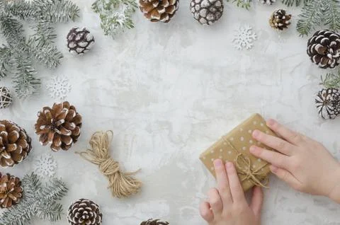 Master class to create a gift box wrapping with kraft paper and rope.Children's Stock Photos