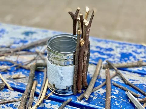 Master class, how to make a vase from sticks and tin cans, kids craft Stock Photos