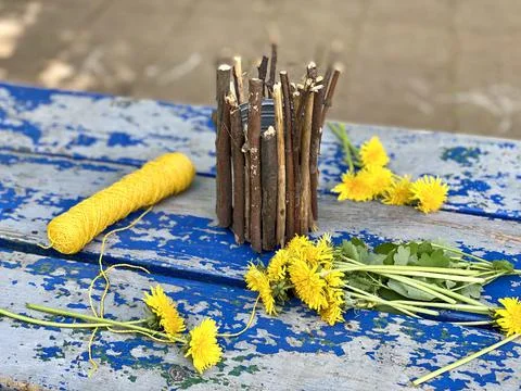 Master class, how to make a vase from sticks and tin cans, kids craft Stock Photos