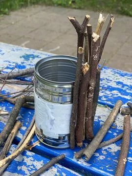 Master class, how to make a vase from sticks and tin cans, kids craft Stock Photos