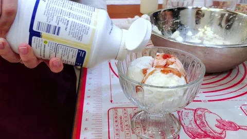 A master class on making ice cream. A child decorates ice cream. Stock Footage 298673950