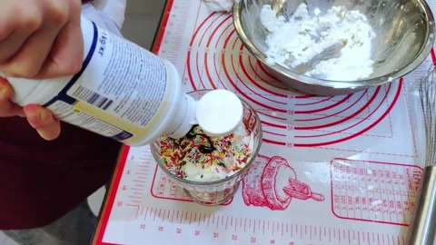 A master class on making ice cream. A child decorates ice cream. Video stock 301184932
