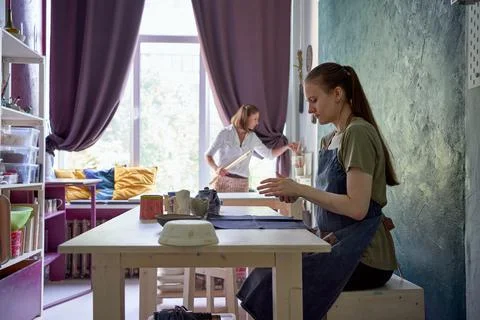 Master-class on making of utensils of clay, one female teaches another Stock Photos