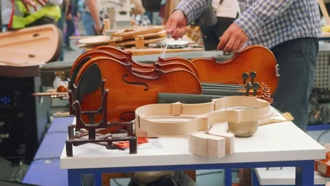 Master class on making violins on city day Stock Footage 98950202