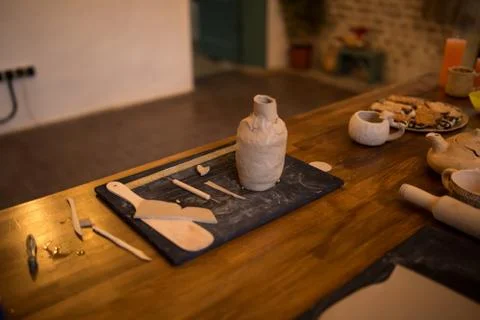 A master class in modeling a clay jug. Table with clay and a tool for creativity Stock Photos