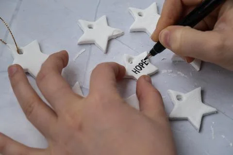 Master class writing word HOPE Creator is using white air dry clay for making Foto stock