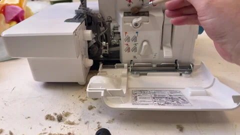 Master clean the overlock sewing machine from dust Stock Footage 306278286