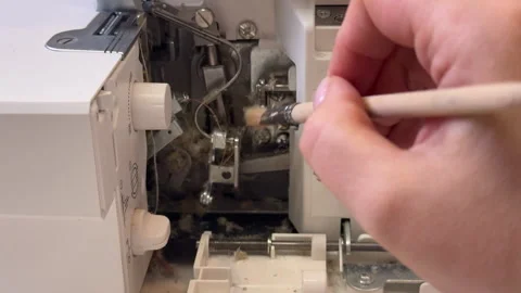 Master clean the overlock sewing machine from dust Stock Footage 306278303
