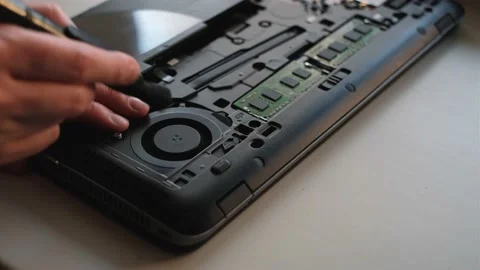 Master cleaning the cooling fan on his laptop 2 Stock Footage 234205732