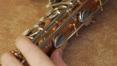 Master Cleans And Repairs The Saxophone Stock Footage 147975613