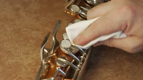 Master Cleans And Repairs The Saxophone Stock Footage 147975633