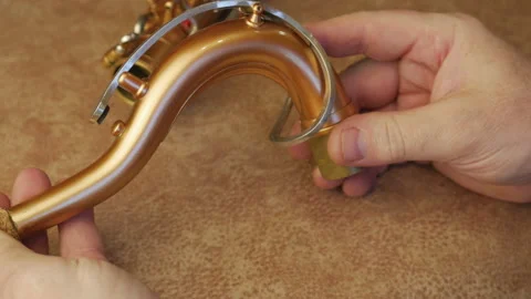 Master Cleans And Repairs The Saxophone Stock Footage 147975833