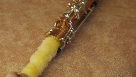 Master Cleans And Repairs The Saxophone Stock Footage 147975896