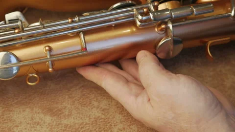 Master Cleans And Repairs The Saxophone Stock Footage 147975924