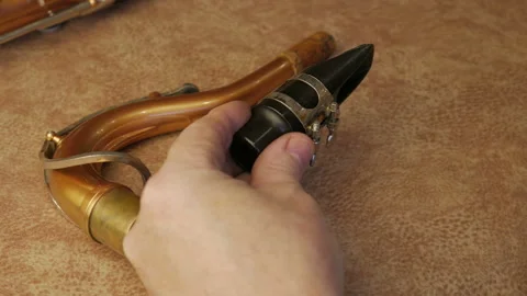 Master Cleans And Repairs The Saxophone Stock Footage 147975947