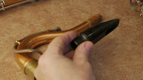 Master Cleans And Repairs The Saxophone Stock-Footage 147976011