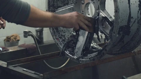 Master cleans the car disk from the old paint Stock Footage 98709026