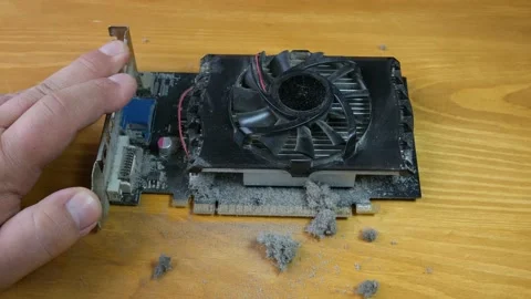 The master cleans the cooler on the video card with a vacuum cleaner. Video stock 133339605