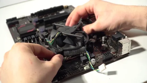 The master collects the computer, fastens the cooler to the motherboard Stock Footage 83168501