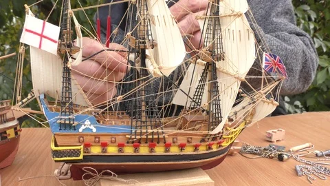 The master collects a model of a sailing ship. Stock Footage 117271062