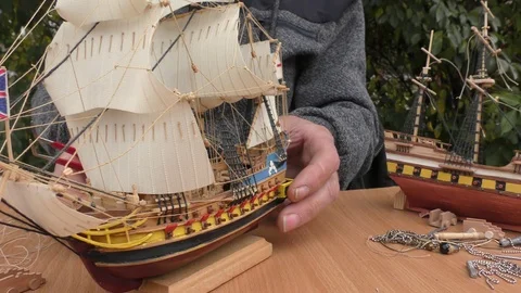 The master collects a model of a sailing ship. Stock Footage 117281458