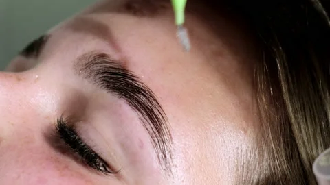 Master combs painted brows of client with micro brush Stock Footage 236579463