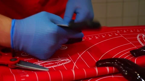 The master confectioner applies the pattern to the soft caramel with a spatula.  Stock Footage 118705977