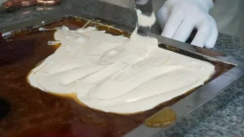 Master confectioner mixed liquid caramel with white day in a confectionery. Stock Footage 330869920