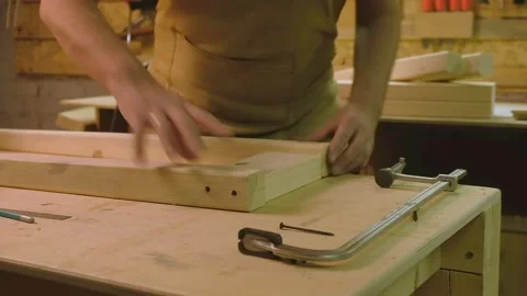 The master connects the boards at right angles and connects them with a clamp Video stock 182224545