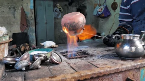 Master coppersmith burns a copper kettle on an open fire. Istanbul Stock Footage 201662240