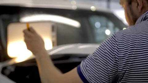 Master corrects small dents and damages to the car. Stock Footage 86267615