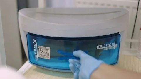 Master cosmetic salon opens a sterilizer with tools for pedicure Stock Footage 81097079