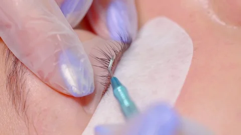 Master cosmetologist is performing procedure of permanent waving of eyelashes 스톡 동영상 97000213