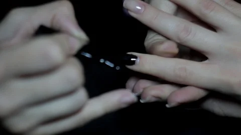 The master covers the client's nails with black varnish. Stock Footage 129522029