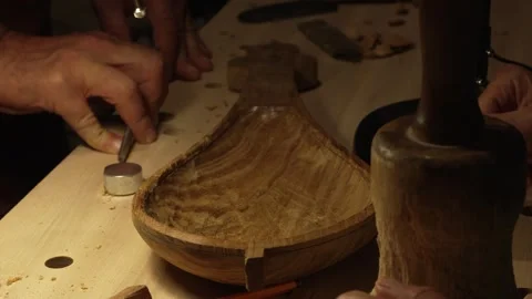 The master crafts traditional wooden string instruments by hand. Stock Footage 342339879