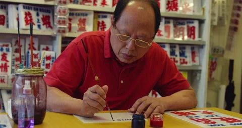 A master craftsman and painter of bus signs in Hong Kong. Shot on red, hand held Stock Footage 201096974